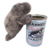 Plush manatee toy holding a can labeled 'Canned Manatee' on a white background
