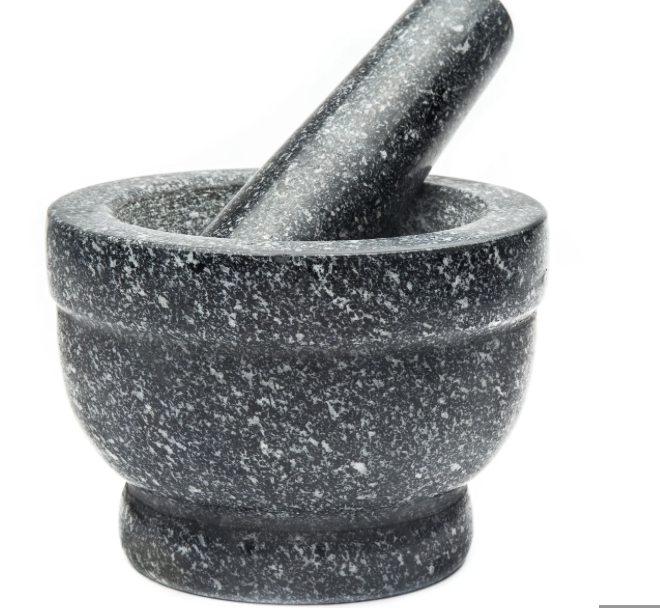 Black stone mortar and pestle on a white background